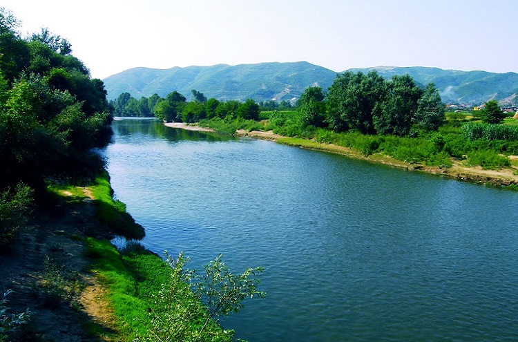 The Shkumbin River has a drainage basin of 2,444 sq. km. (or 944 sq. mi.) with an east-west direction across Central Albania.